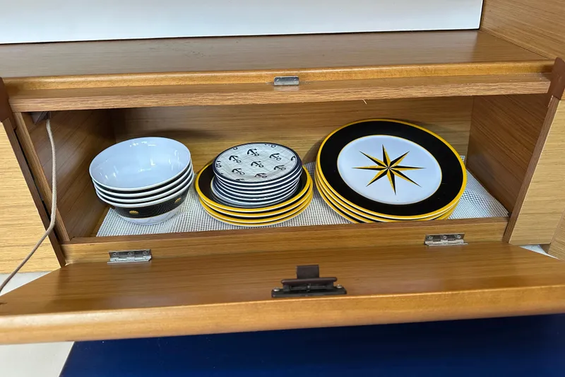 Slide: The Image of Wooden cabinet with nautical-themed plates and bowls on Jeanneau Sun Odyssey 45 DS, 2008. - 40