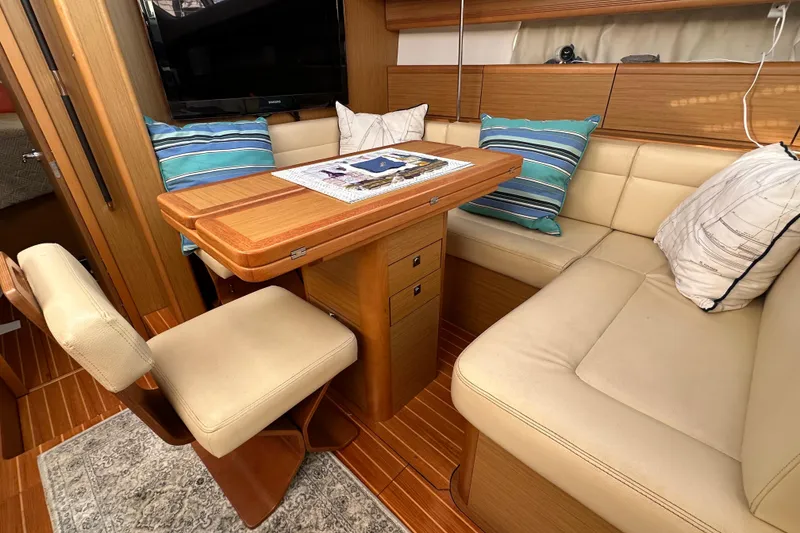 Slide: The Image of Interior of 2008 Jeanneau Sun Odyssey 45 DS with cozy seating and wooden table. - 55