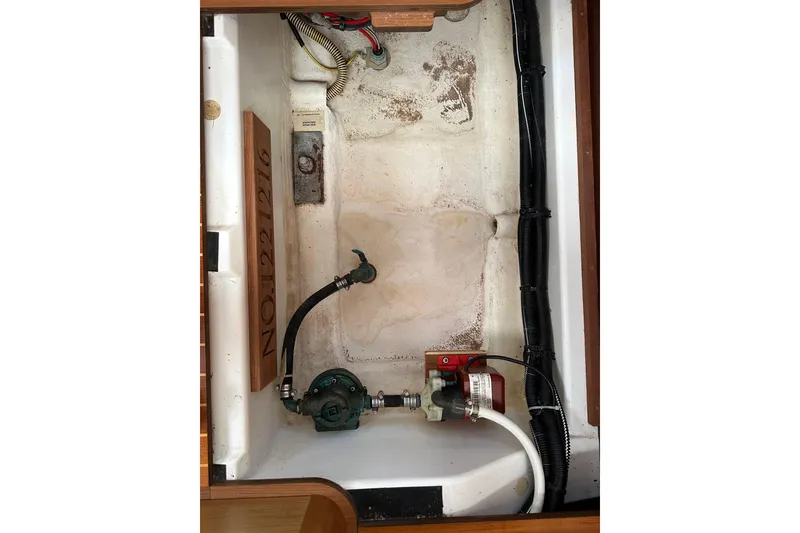 Slide: The Image of Bilge area of 2008 Jeanneau Sun Odyssey 45 DS sailboat, showing pump and wiring. - 57