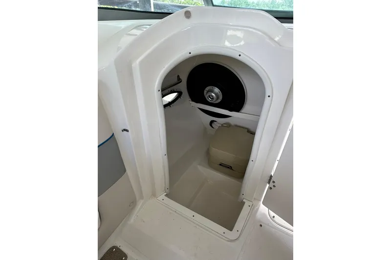 Slide: The Image of 2013 Rinker 276 Captiva Bowrider interior cabin with compact toilet. - 10