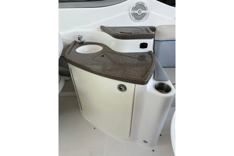 Slide: The Image of 2013 Rinker 276 Captiva Bowrider interior with sink and storage area. - 21