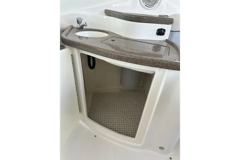 Slide: The Image of 2013 Rinker 276 Captiva Bowrider boat interior with sink and storage compartment. - 22