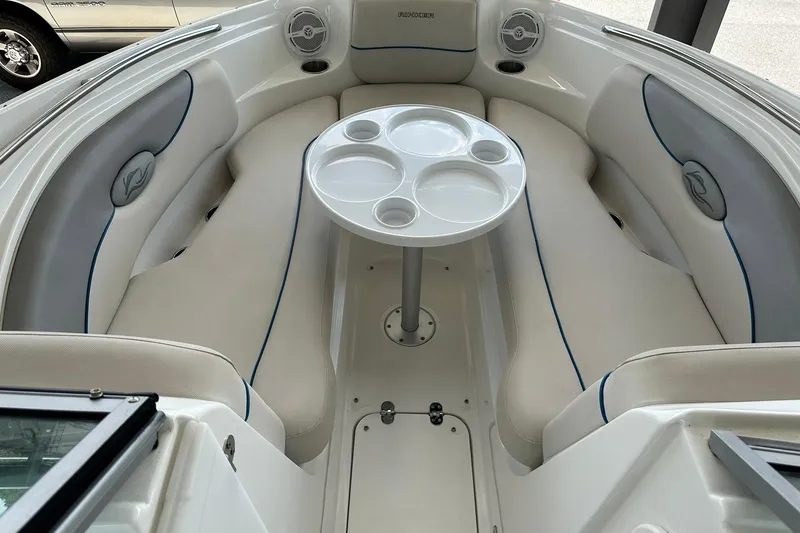 Slide: The Image of 2013 Rinker 276 Captiva Bowrider interior with white seating and round table. - 24