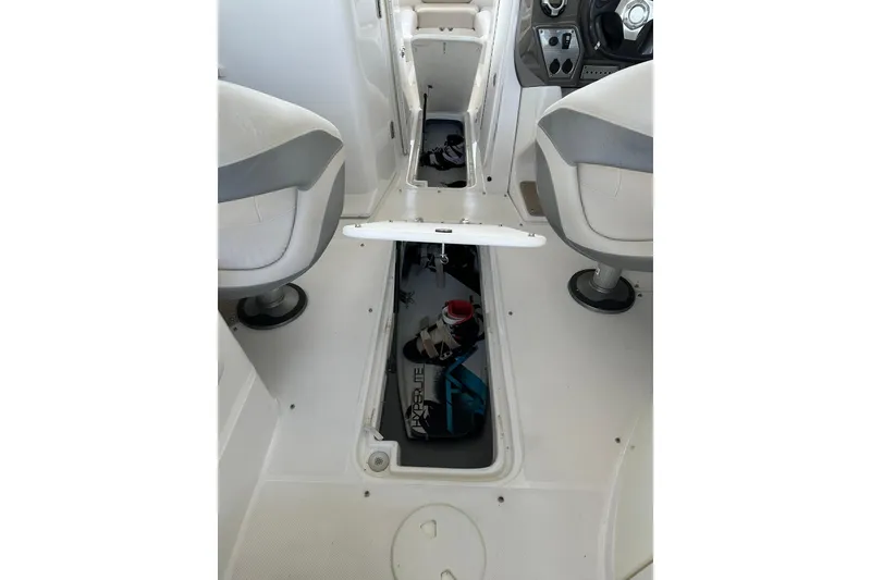 Slide: The Image of 2013 Rinker 276 Captiva Bowrider interior with open storage compartment. - 27