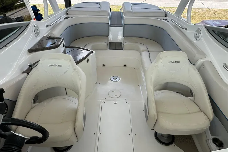 Slide: The Image of 2013 Rinker 276 Captiva Bowrider interior with white seating and sleek design. - 3