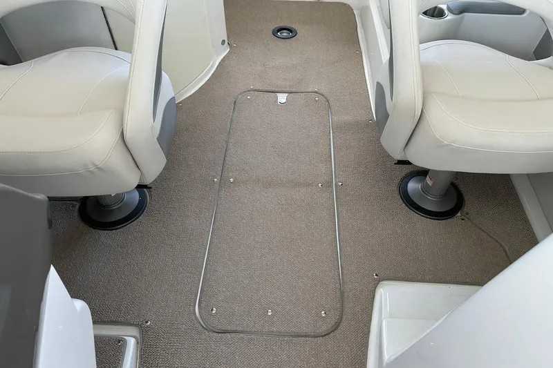 Slide: The Image of Interior of 2013 Rinker 276 Captiva Bowrider with beige seating and carpeted floor. - 30