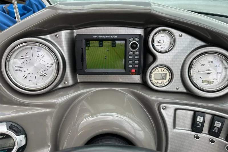 Slide: The Image of 2013 Rinker 276 Captiva Bowrider dashboard with gauges and navigation system. - 32