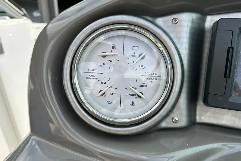 Slide: The Image of Dashboard gauge of 2013 Rinker 276 Captiva Bowrider showing fuel, oil, volts, and temperature. - 33