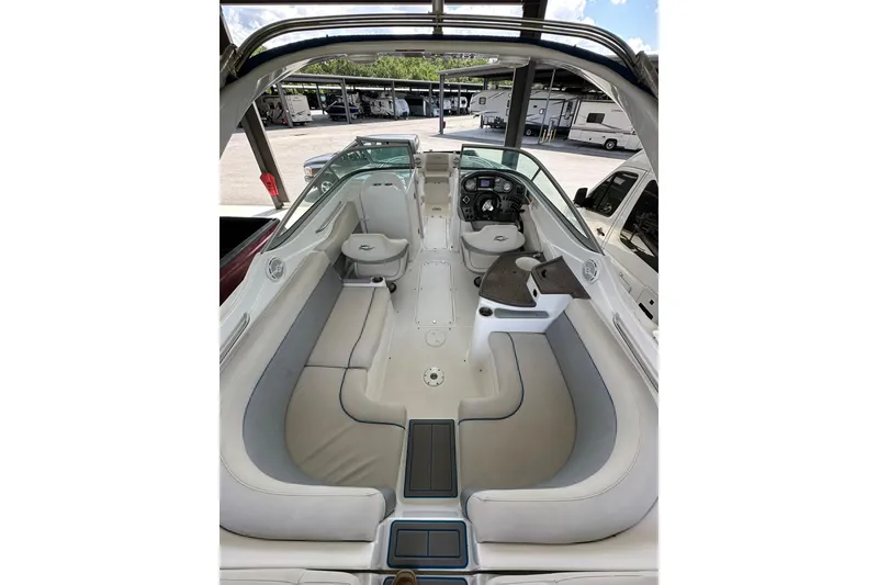 Slide: The Image of 2013 Rinker 276 Captiva Bowrider interior with spacious seating and modern dashboard. - 7