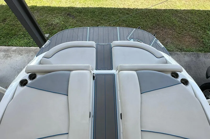 Slide: The Image of 2013 Rinker 276 Captiva Bowrider boat interior with cushioned seating and cup holders. - 8