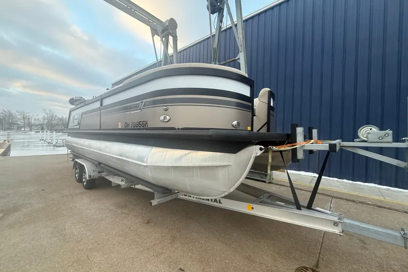 Slide: The Image of 2022 Viaggio Diamante 23U pontoon boat on trailer near blue building. - 7