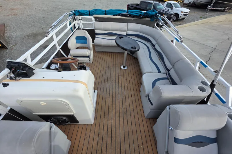 Slide: The Image of 2001 J C Manufacturing TRITOON 226 I/O with spacious seating and wooden deck. - 2