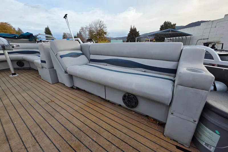 Slide: The Image of 2001 J C Manufacturing TRITOON 226 I/O boat with spacious seating on wooden deck. - 4