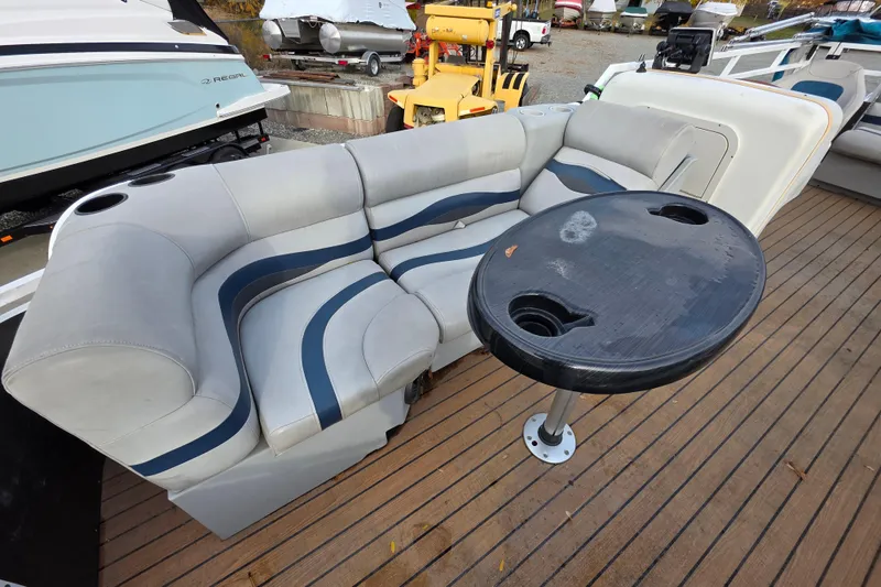 Slide: The Image of 2001 J C Manufacturing TRITOON 226 I/O boat interior with cushioned seating and table. - 5