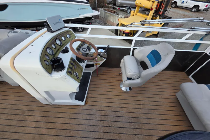 Slide: The Image of 2001 J C Manufacturing TRITOON 226 I/O boat helm with Garmin GPS and seating. - 7