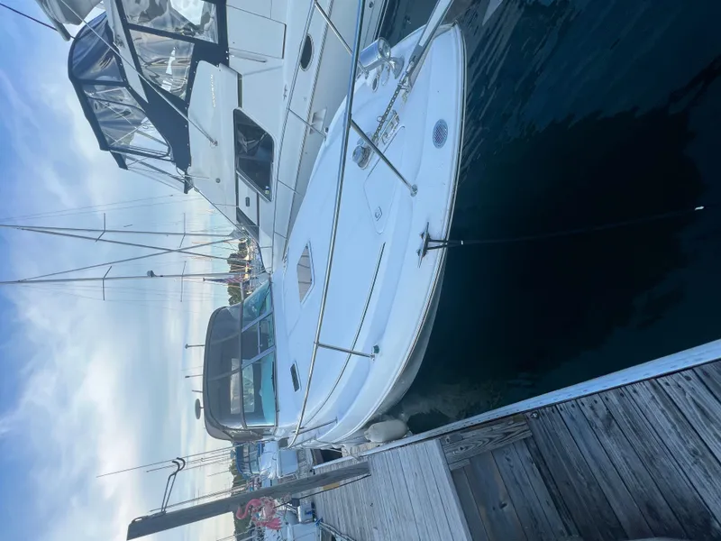 Slide: The Image of 1999 Sea Ray Sundancer 310 docked, calm water. - 24