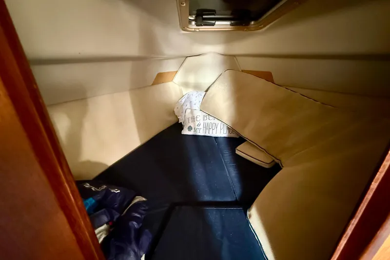 Slide: The Image of Cozy cabin interior of 2000 Hunter 290 sailboat with cushions and bedding. - 10