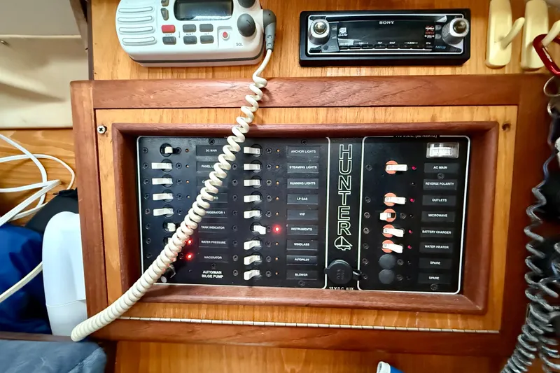 Slide: The Image of Electrical panel of a 2000 Hunter 290 sailboat with radio and controls. - 12