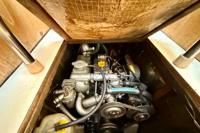 Slide: The Image of Engine compartment of a 2000 Hunter 290 sailboat, showcasing mechanical components. - 13