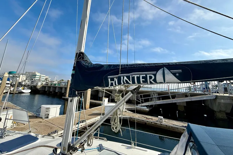 Slide: The Image of Sailboat Hunter 290 (2000) docked at marina under clear blue sky. - 18
