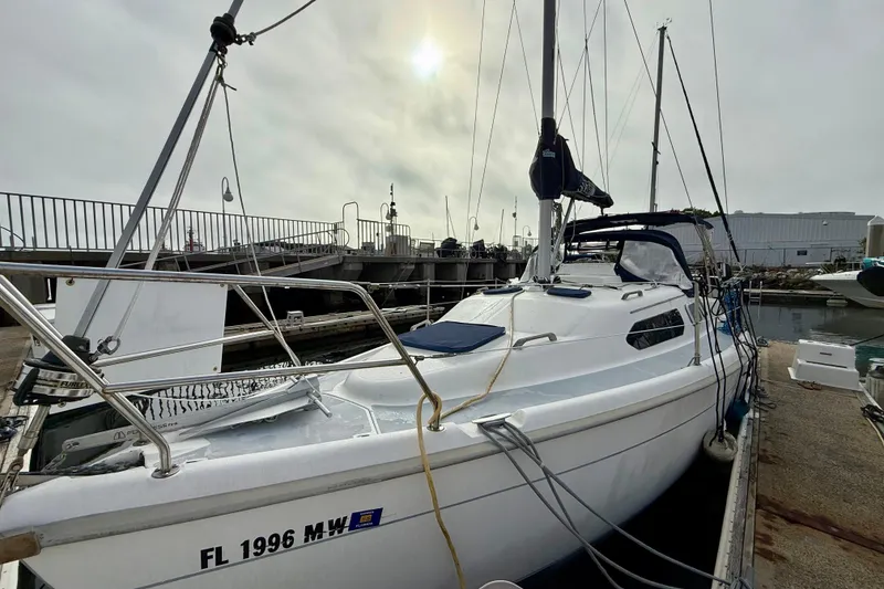 Slide: The Image of Sailboat docked at marina, Hunter 290 model, year 2000, under cloudy sky. - 5