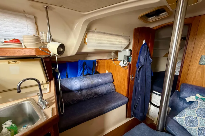 Slide: The Image of Cozy interior of a 2000 Hunter 290 sailboat with seating and kitchenette. - 7