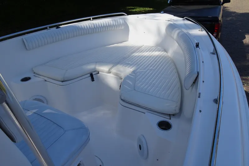 Slide: The Image of 2007 Sea Hunt Triton 232 boat interior with white cushioned seating. - 10