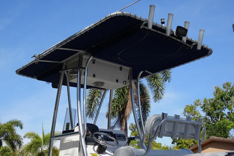 Slide: The Image of 2007 Sea Hunt Triton 232 boat with T-top against a clear blue sky. - 14