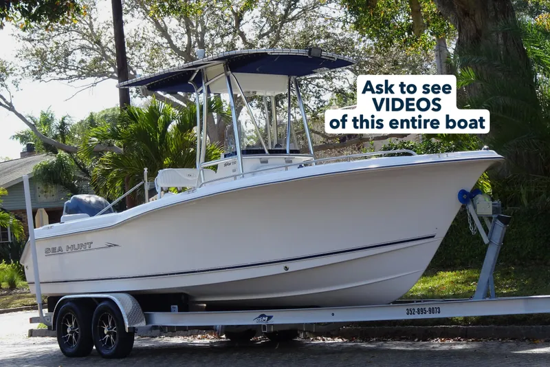 Slide: The Image of 2007 Sea Hunt Triton 232 boat on trailer, surrounded by trees and greenery. - 4
