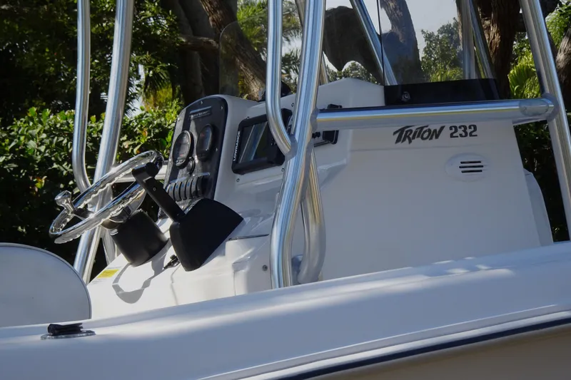 Slide: The Image of 2007 Sea Hunt Triton 232 boat console with steering wheel and controls. - 8