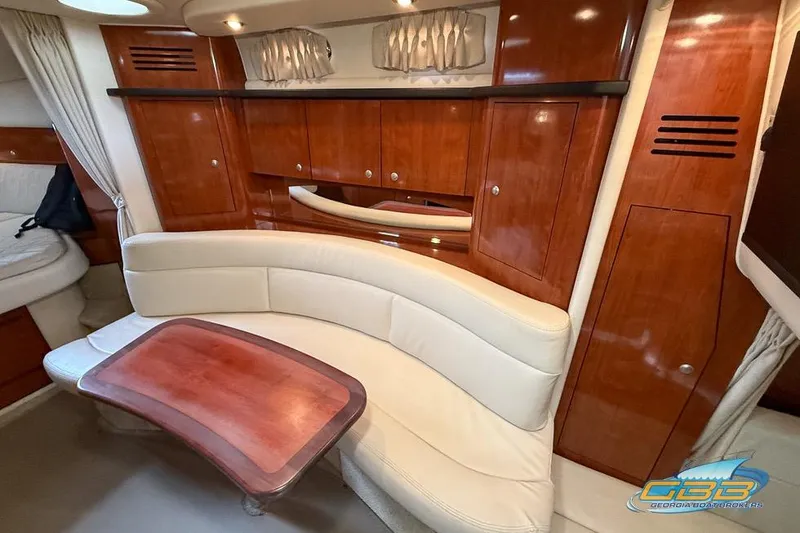 Slide: The Image of Luxurious 2007 Sea Ray Sundancer 320 interior with elegant wood finish and curved seating. - 18