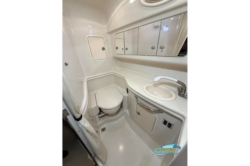 Slide: The Image of 2007 Sea Ray Sundancer 320 bathroom with toilet, sink, and storage cabinets. - 24