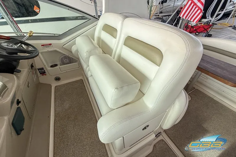 Slide: The Image of 2007 Sea Ray Sundancer 320 interior with white leather seating and steering wheel. - 25
