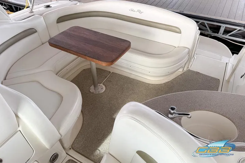 Slide: The Image of Luxurious 2007 Sea Ray Sundancer 320 interior with elegant seating and wooden table. - 27