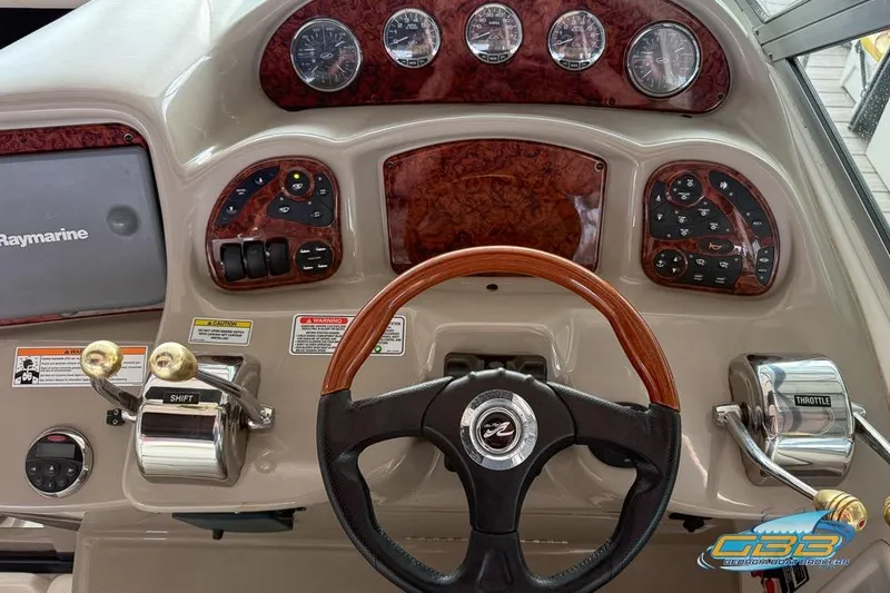 Slide: The Image of 2007 Sea Ray Sundancer 320 helm with wood accents and Raymarine electronics. - 28