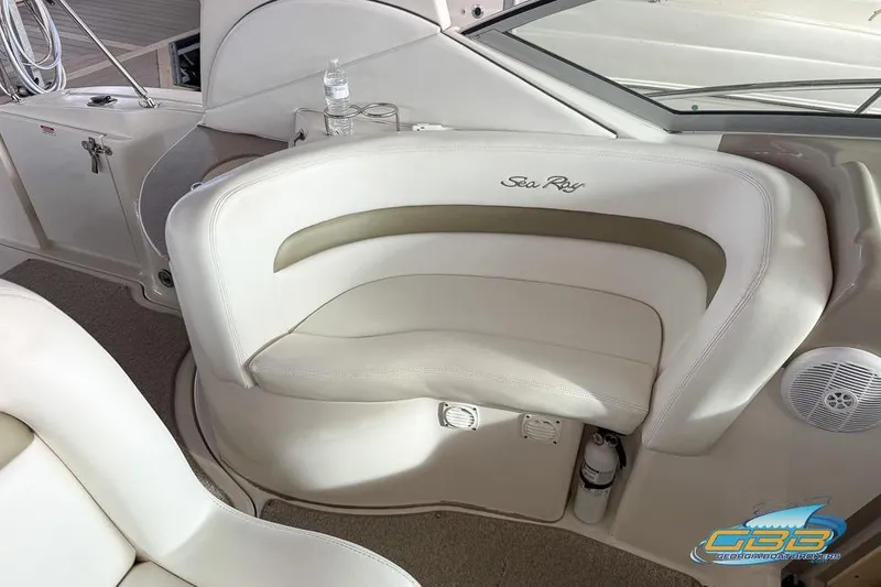 Slide: The Image of 2007 Sea Ray Sundancer 320 interior seating with logo, featuring white and beige upholstery. - 29