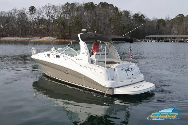 Slide: The Image of 2007 Sea Ray Sundancer 320 cruising on a calm lake with forested shoreline. - 3