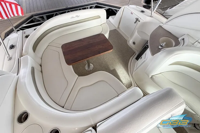 Slide: The Image of Luxurious 2007 Sea Ray Sundancer 320 boat interior with plush seating and wooden table. - 30