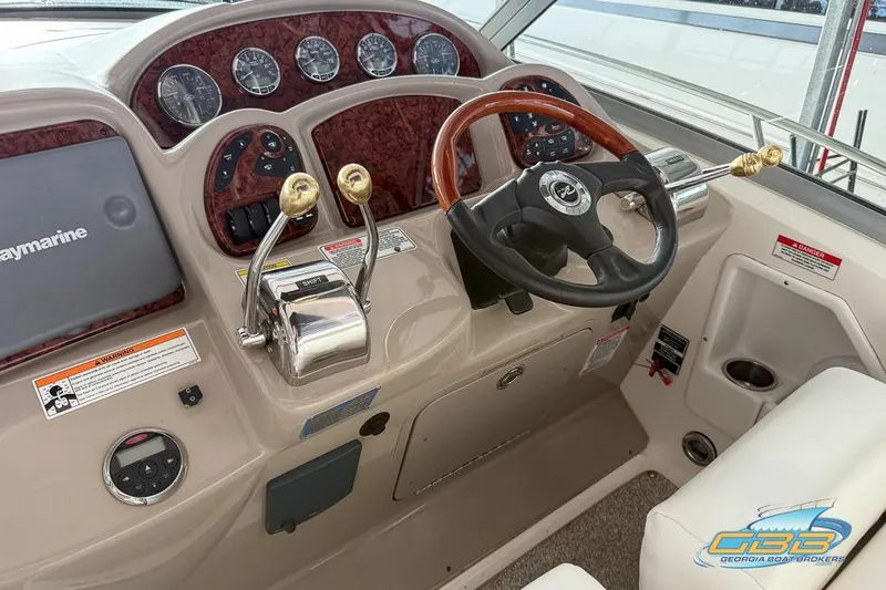 Slide: The Image of 2007 Sea Ray Sundancer 320 helm with wood-accented steering wheel and control panel. - 32