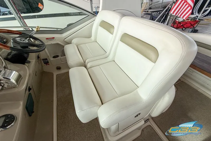 Slide: The Image of 2007 Sea Ray Sundancer 320 cockpit with white leather seats and steering wheel. - 33