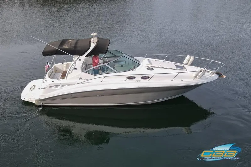Slide: The Image of 2007 Sea Ray Sundancer 320 boat on calm water, featuring sleek design and spacious deck. - 4
