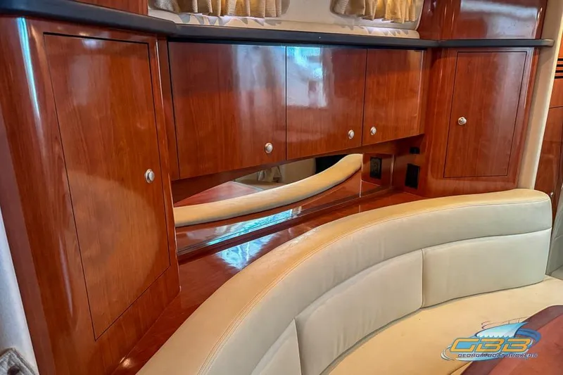 Slide: The Image of Luxurious interior of 2007 Sea Ray Sundancer 320 with polished wood cabinetry and cream seating. - 52