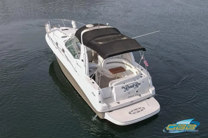 Slide: The Image of 2007 Sea Ray Sundancer 320 boat on water, rear view with canopy and American flag. - 7