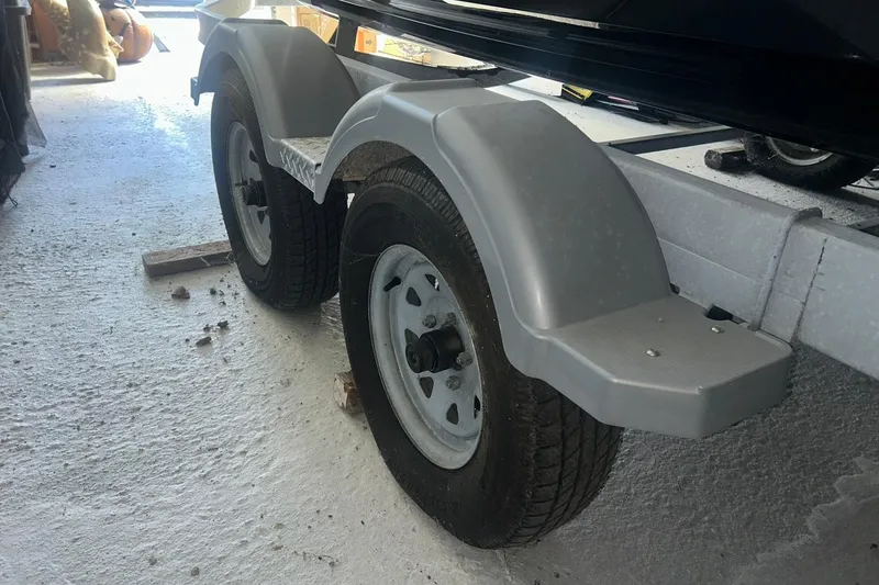 Slide: The Image of Trailer wheels for 2017 Bayliner VR6 Bowrider I/O boat in a garage setting. - 31