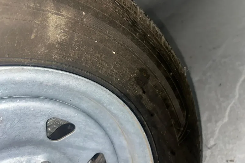 Slide: The Image of Close-up of a tire and wheel from a 2017 Bayliner VR6 Bowrider I/O. - 32