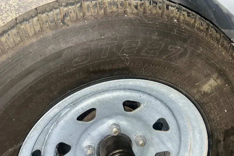 Slide: The Image of Close-up of a tire on a 2017 Bayliner VR6 Bowrider I/O trailer. - 33