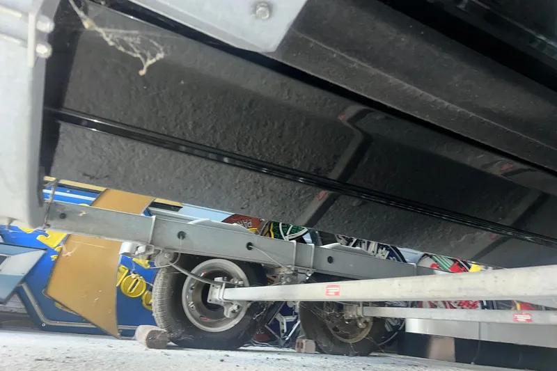 Slide: The Image of 2017 Bayliner VR6 Bowrider I/O on trailer, underside view with wheel and frame visible. - 37