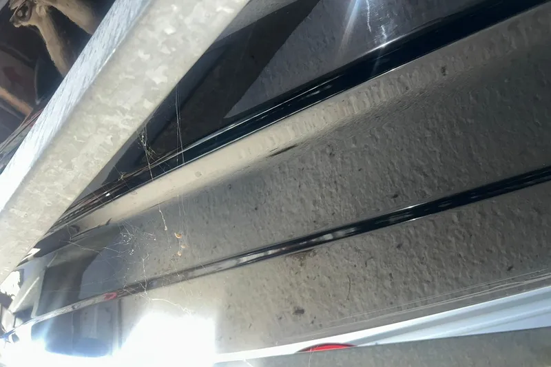 Slide: The Image of Close-up of 2017 Bayliner VR6 Bowrider I/O hull with cobwebs and reflections. - 39