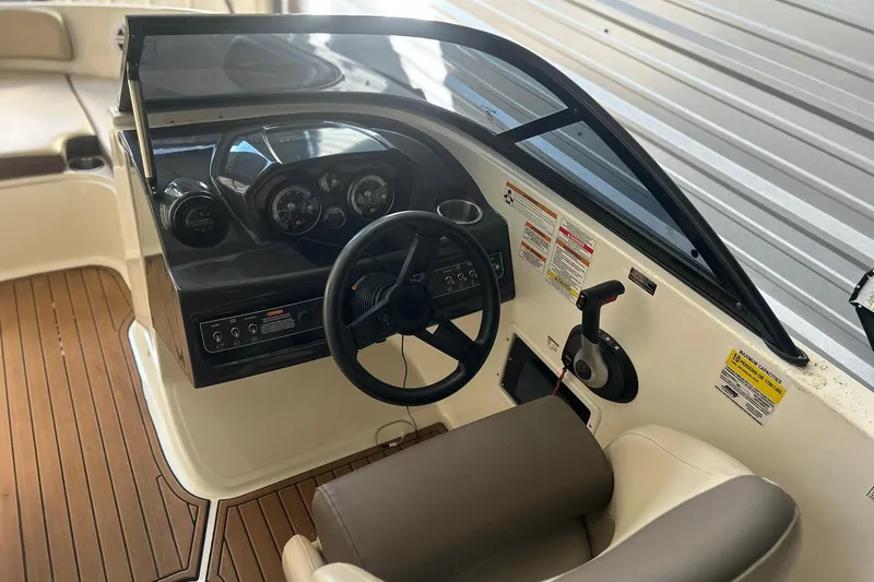 Slide: The Image of 2017 Bayliner VR6 Bowrider I/O dashboard with steering wheel and controls. - 4