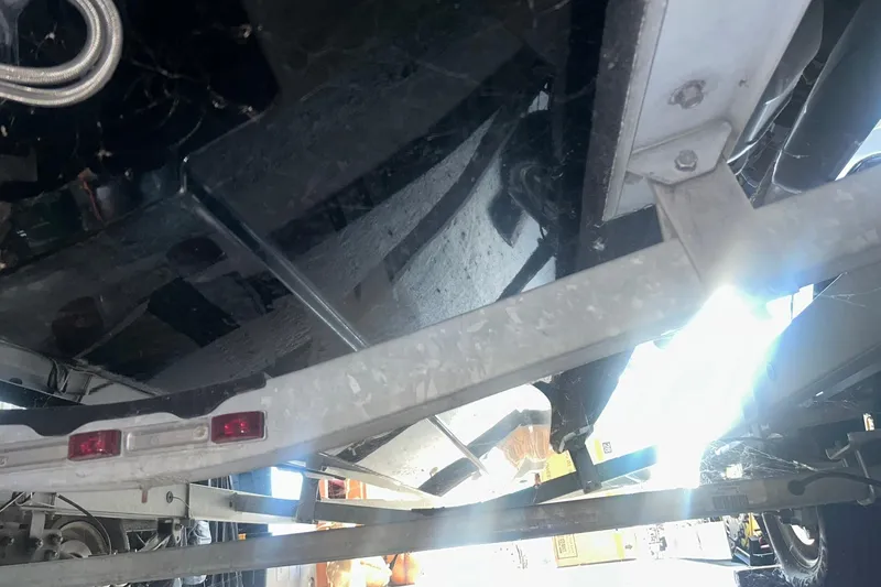 Slide: The Image of 2017 Bayliner VR6 Bowrider I/O boat underside on trailer, showing hull and support structure. - 41